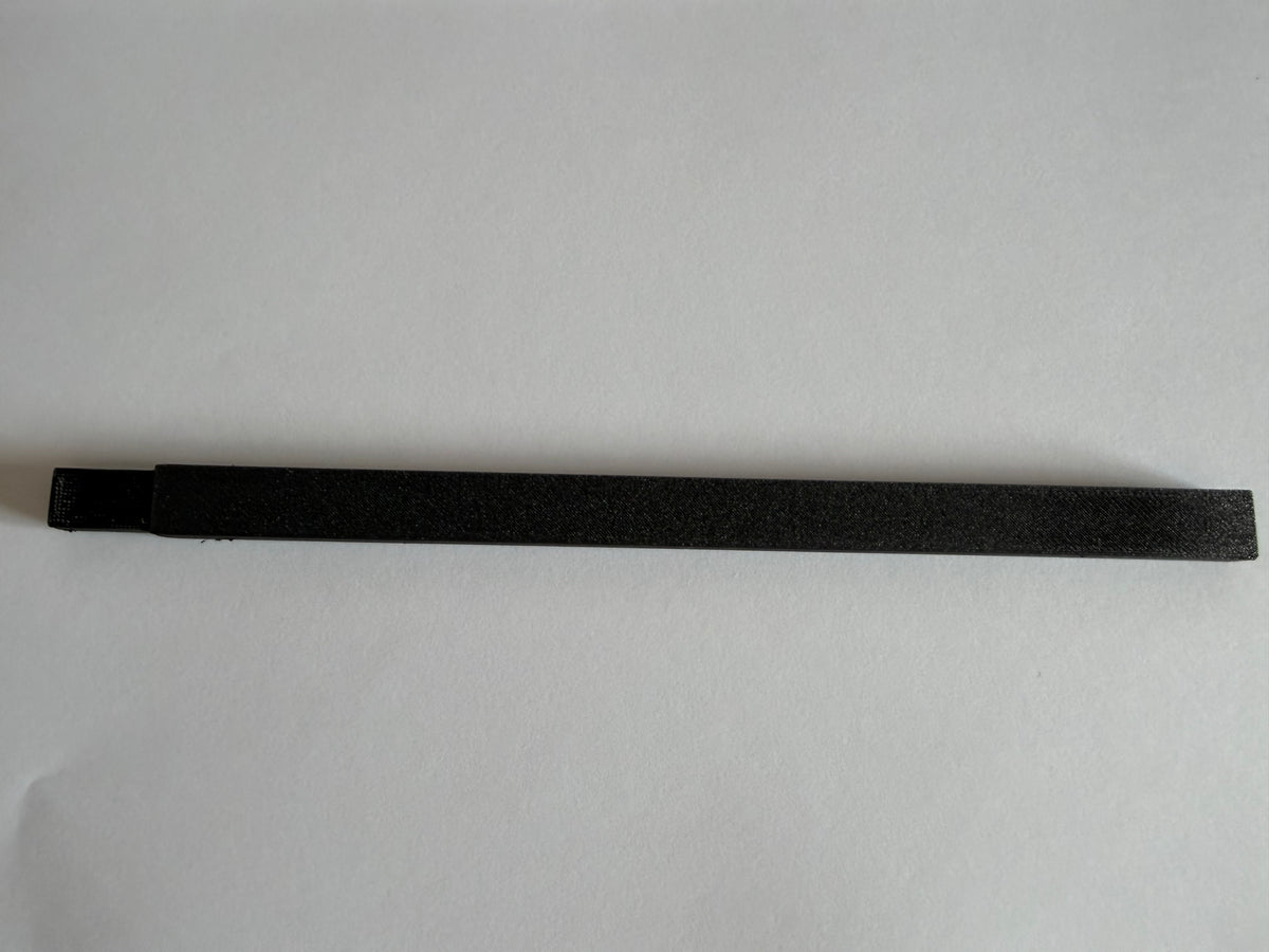 Black cable duct cover on a plain background, side angle