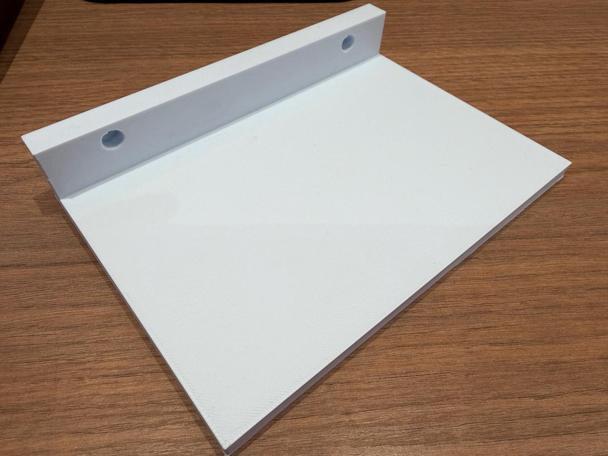 White acrylic perfume shelf shown alone on a wood surface