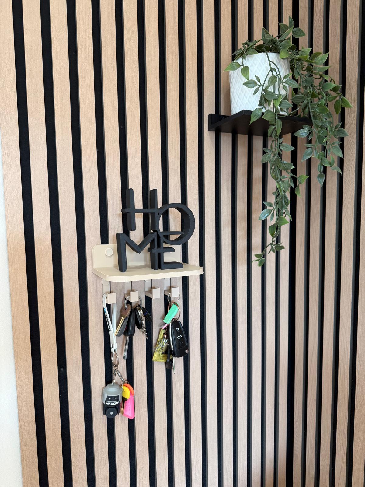 Key holder shelf on a slat wall styled with a plant, vase and hanging keys, front view