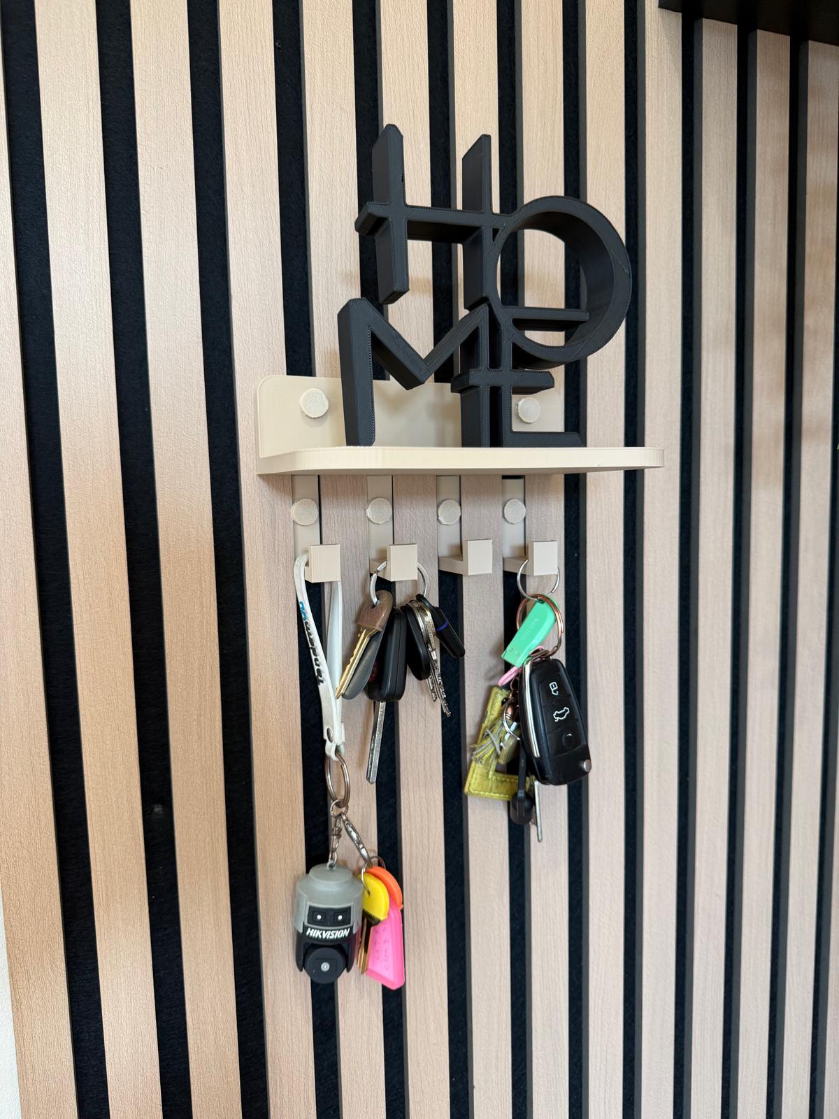 Key holder shelf on a slat wall styled with a plant and hanging keys, close-up