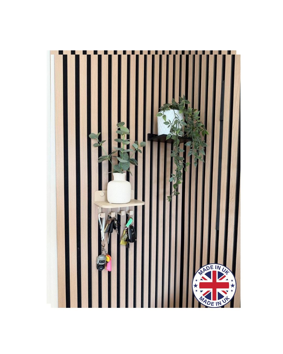 Key holder shelf on a slat wall from a distance, styled with plant and hanging keys