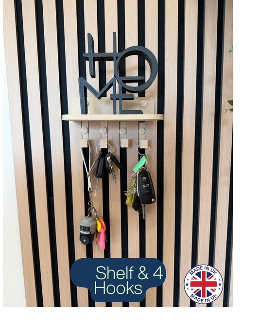 Key holder shelf on a slat wall styled with a plant, vase and hanging keys, with HOME wall art above
